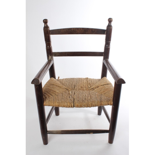 614 - A vintage child's chair with rattan seat.