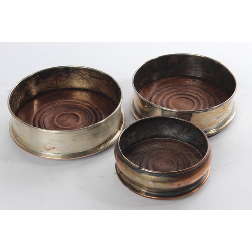 623 - Three silver plated bottle coasters.