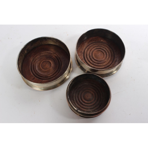 623 - Three silver plated bottle coasters.