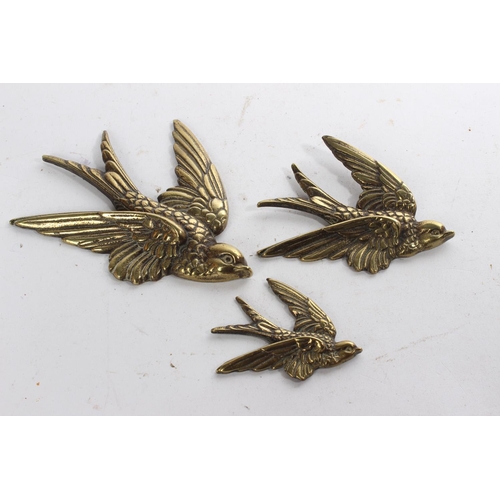 626 - A set of three vintage brass bird plaques.