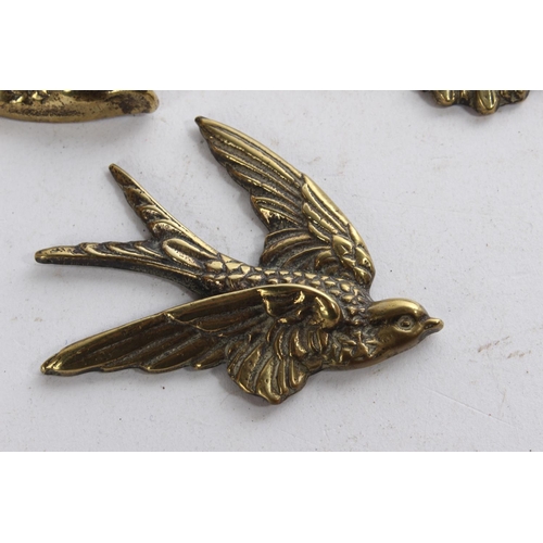 626 - A set of three vintage brass bird plaques.