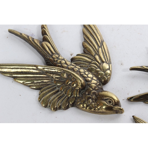 626 - A set of three vintage brass bird plaques.