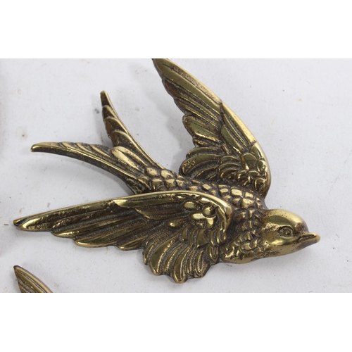 626 - A set of three vintage brass bird plaques.