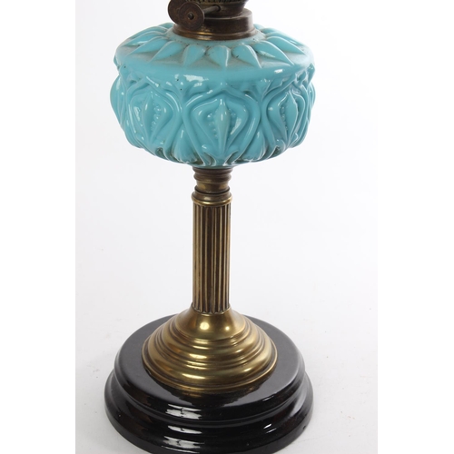 629 - A stunning Antique oil lamp with blue glass font and a stunning ruby glass shade.