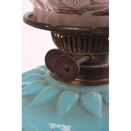 629 - A stunning Antique oil lamp with blue glass font and a stunning ruby glass shade.