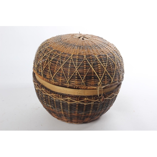 636 - A vintage rattan sewing basket and its contents.