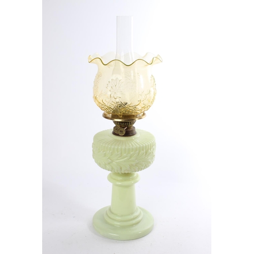 641 - A stunning antique uranium glass oil lamp and an amber glass shade.