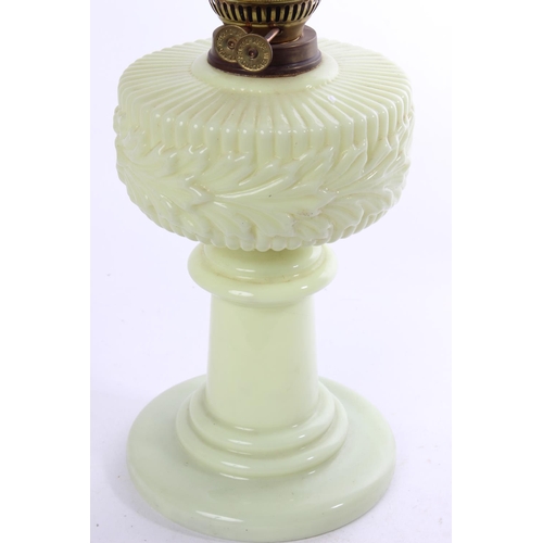 641 - A stunning antique uranium glass oil lamp and an amber glass shade.