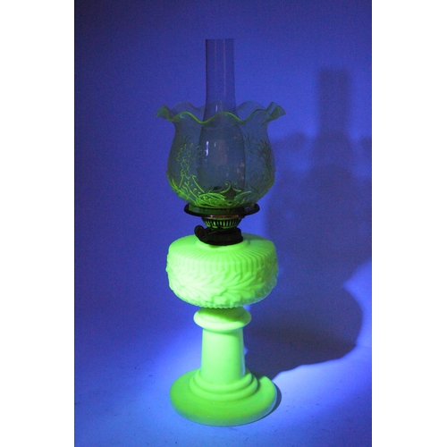 641 - A stunning antique uranium glass oil lamp and an amber glass shade.