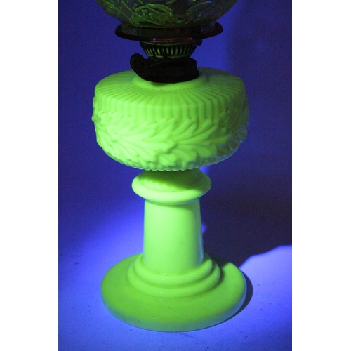 641 - A stunning antique uranium glass oil lamp and an amber glass shade.