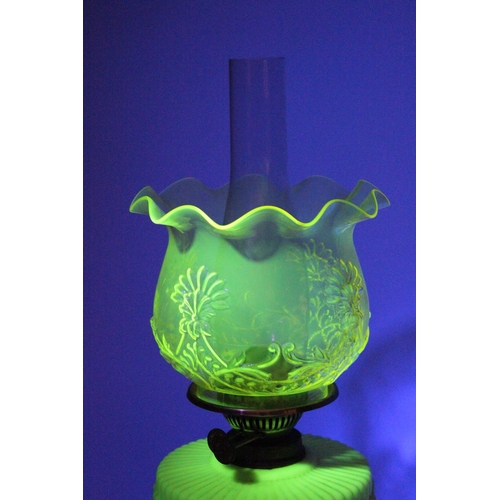 641 - A stunning antique uranium glass oil lamp and an amber glass shade.