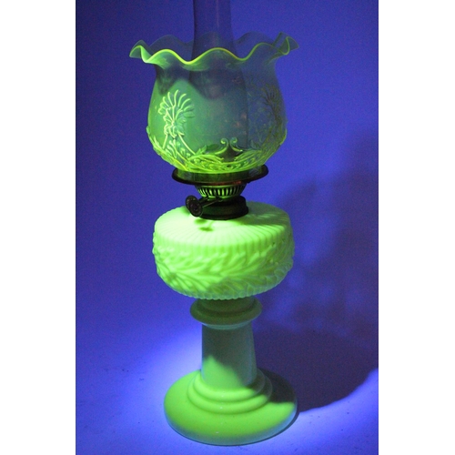 641 - A stunning antique uranium glass oil lamp and an amber glass shade.