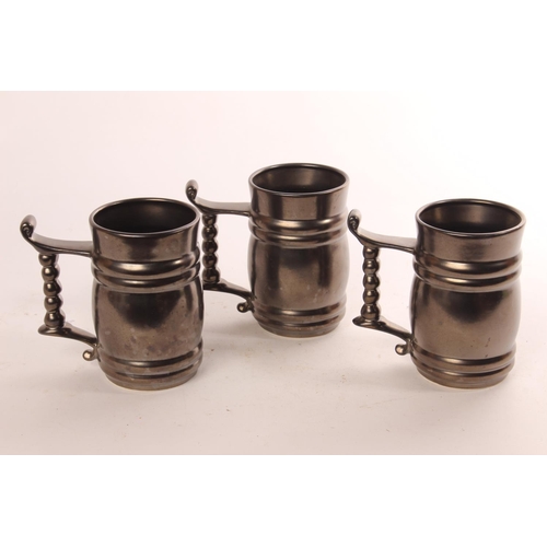 643 - Three pewter style ceramic tankards.