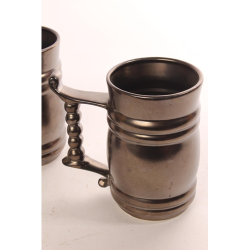 643 - Three pewter style ceramic tankards.