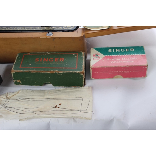 648 - A vintage cased electric Singer sewing machine, instructions and more.