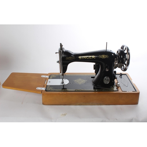 648 - A vintage cased electric Singer sewing machine, instructions and more.