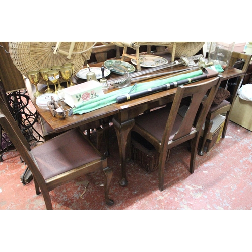 677 - A vintage mahogany drop leaf dining room table and a set of four leather upholstered chairs.