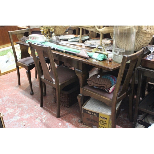 677 - A vintage mahogany drop leaf dining room table and a set of four leather upholstered chairs.