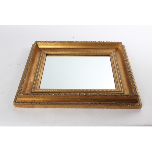 687 - A small gilt framed wall mirror.