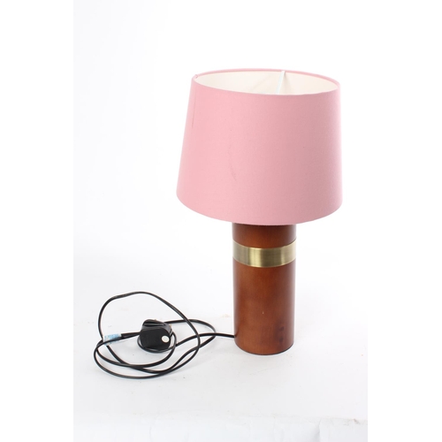 701 - A vintage wooden based table lamp and shade.