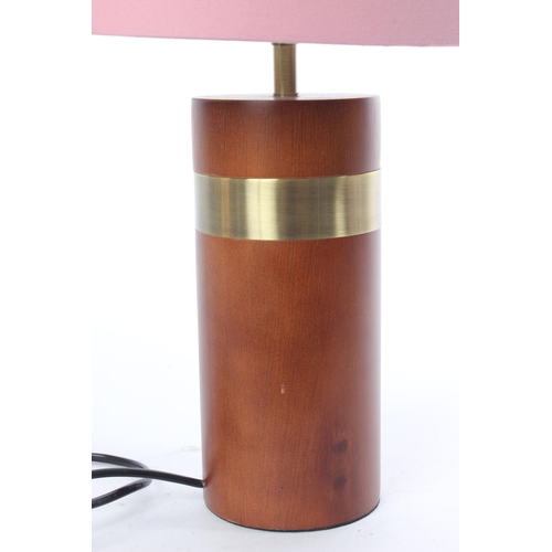 701 - A vintage wooden based table lamp and shade.