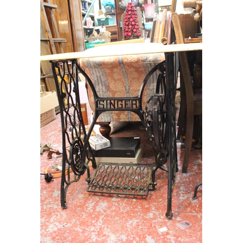 704 - An antique cast iron Singer base converted to a table.