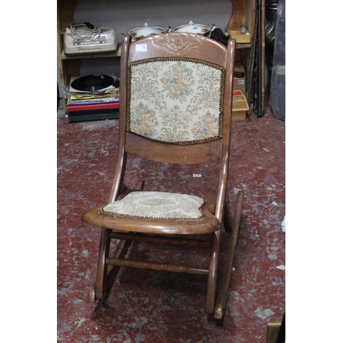 709 - A mahogany upholstered folding chair.