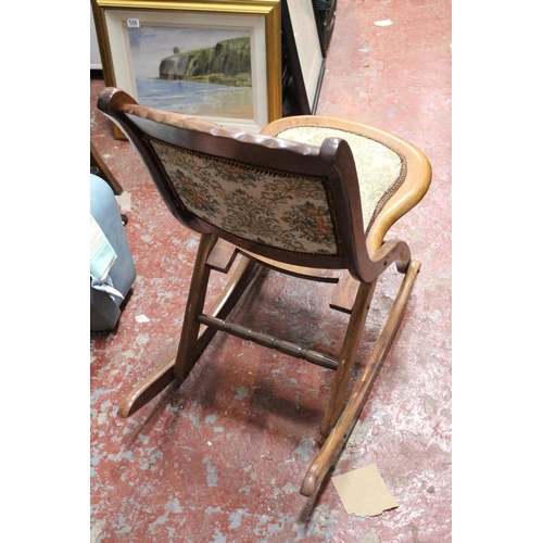 709 - A mahogany upholstered folding chair.