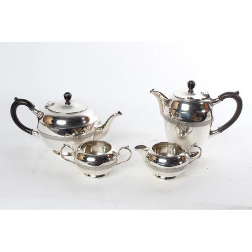 719 - A four piece Walker & Hall silver plated tea service.