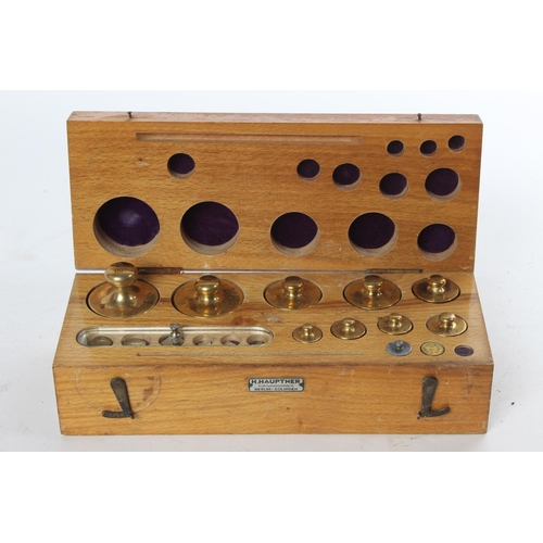 720 - A wood cased set of brass weights by H Hauptner, Berlin.