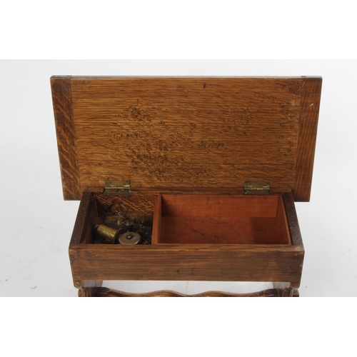 732 - A vintage oak musical jewellery box in the style of a table.