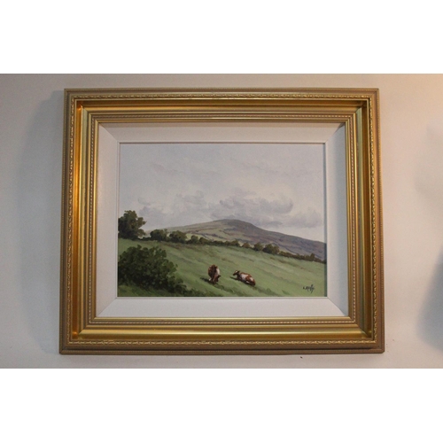 741 - A gilt framed oil painting 'Cattle Grazing' signed Liam Reilly.