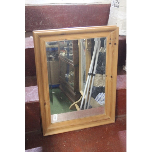 757 - A pine framed wall mirror.