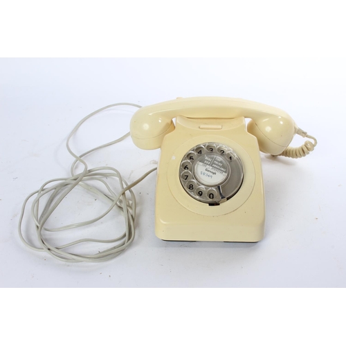 766 - A vintage cream rotary telephone.