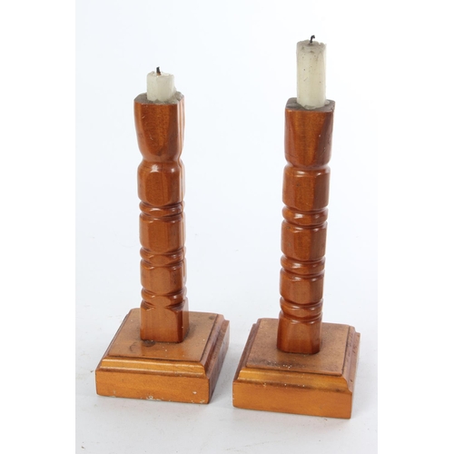 768 - A pair of wooden candlesticks.