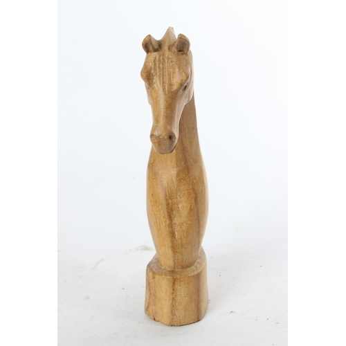 774 - A wooden figure of a horses head.