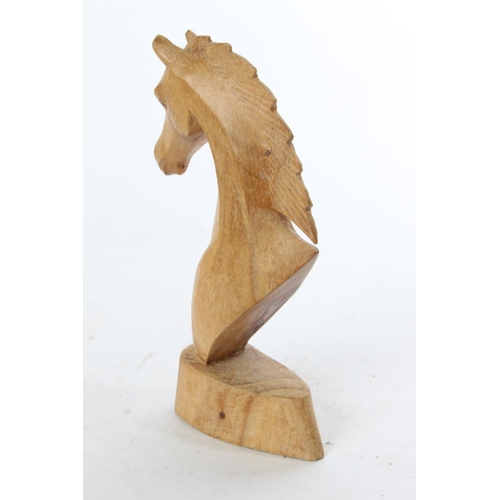 774 - A wooden figure of a horses head.