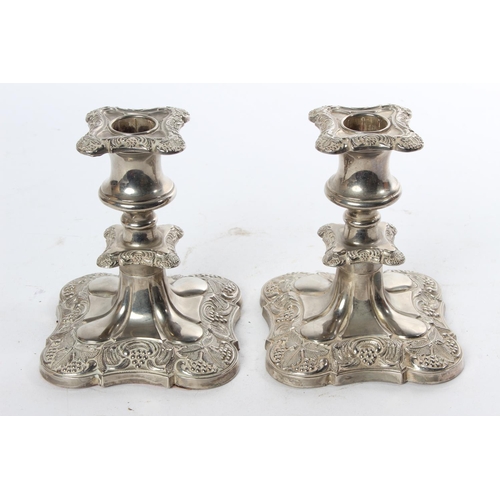 788 - A pair of silver plated candlesticks.