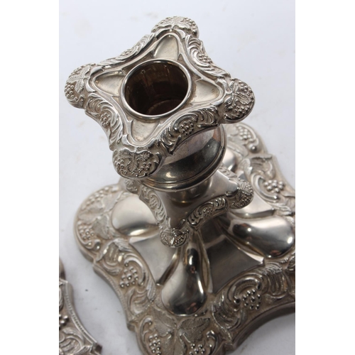 788 - A pair of silver plated candlesticks.