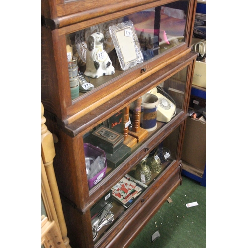 794 - A stunning antique oak five section Barrister bookcase, with glass front, up and over doors, measuri... 