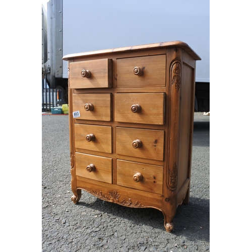 803 - A small pine chest of 8 drawer, with carved corner panels.