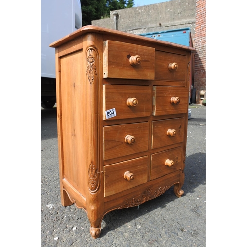 803 - A small pine chest of 8 drawer, with carved corner panels.