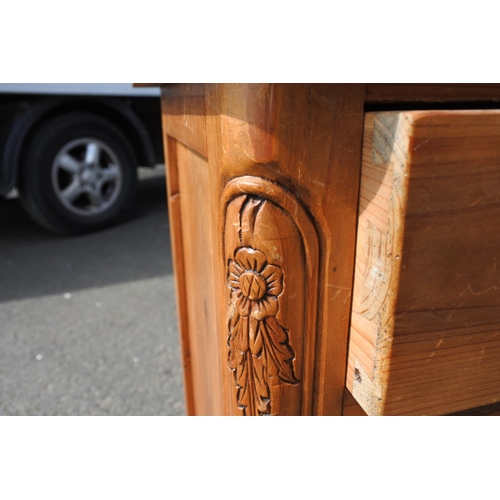 803 - A small pine chest of 8 drawer, with carved corner panels.