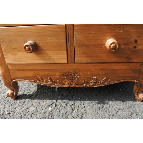 803 - A small pine chest of 8 drawer, with carved corner panels.