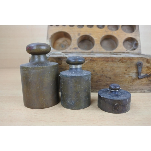 810 - A wood cased set of brass weights.