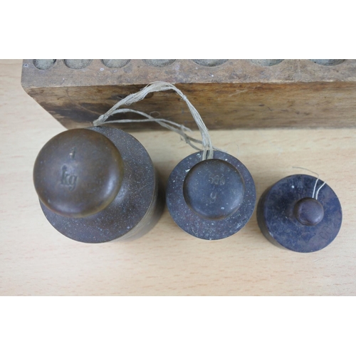 810 - A wood cased set of brass weights.