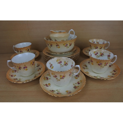 811 - An antique pottery tea set with floral pattern, Reg No 423761.