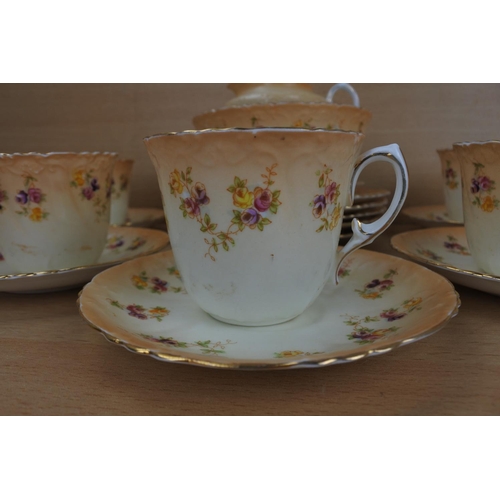 811 - An antique pottery tea set with floral pattern, Reg No 423761.