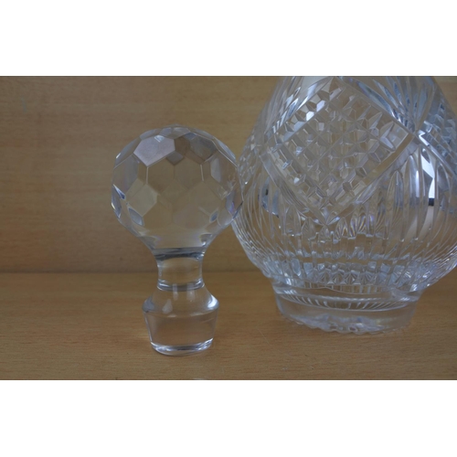 816 - A cut glass decanter and stopper.