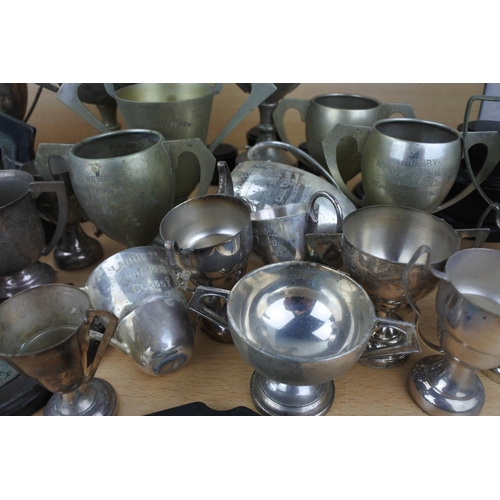 820 - A large lot of silver plated presentation cups.